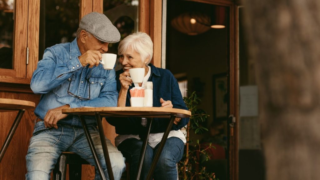 Retired couple enjoying a coffee in a city